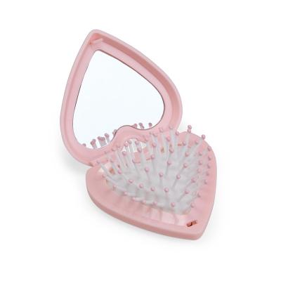 Escova com espelho em formato de coração, prática e compacta para o dia a dia. Feita em plástico,...